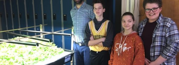 A few of the Hillcrest gardeners, including, from left, teacher Marc Merhebi, and students Connor Campbell, Aidyn Bulmer and Cameron LeBlanc. (Vanessa Blanch/CBC)