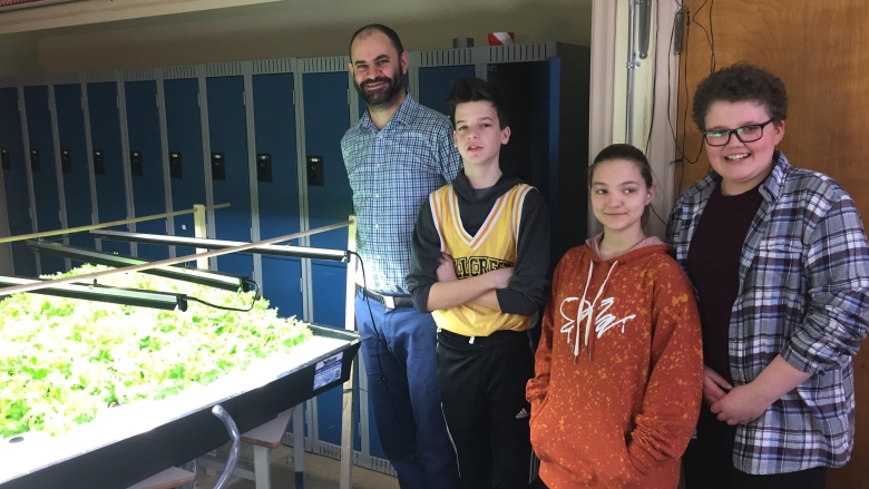 A few of the Hillcrest gardeners, including, from left, teacher Marc Merhebi, and students Connor Campbell, Aidyn Bulmer and Cameron LeBlanc. (Vanessa Blanch/CBC)