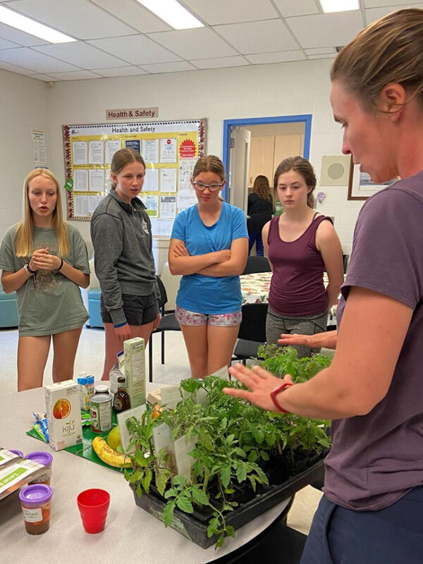 Instructor teaching young girls about cooking